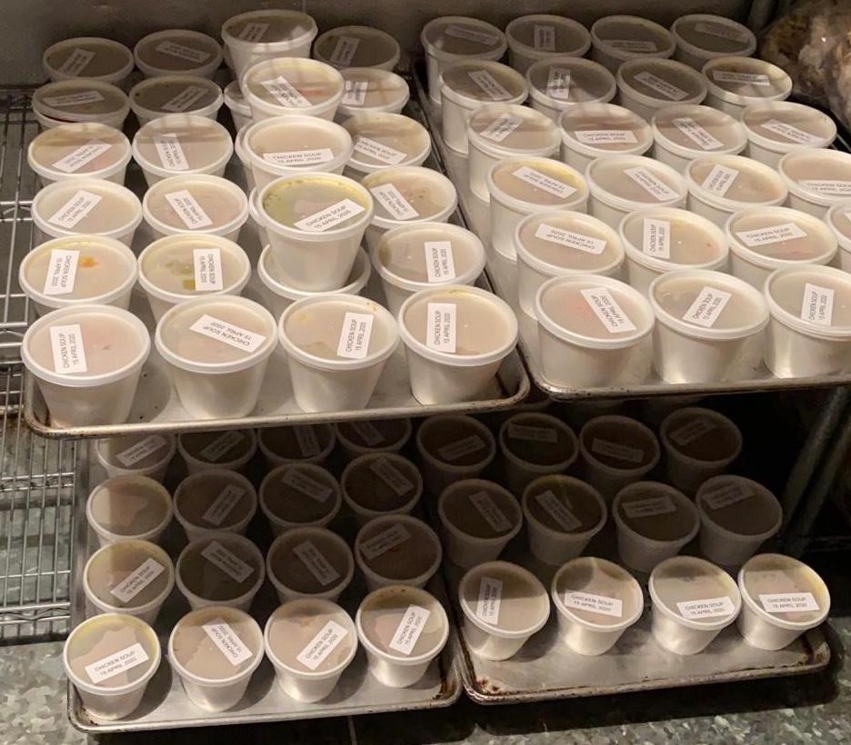 two-shelves-of-soup-containers-with-labels-on-top